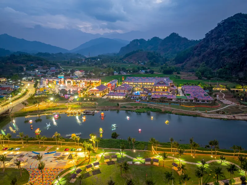 Flamingo Tân Trào lên đèn lúc chạng vạng bên sông Phó Đáy, xung quanh là đồng lúa và núi đá Tuyên Quang