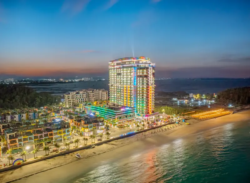 Flamingo Hải Tiến lên đèn lúc chạng vạng, tòa khách sạn nhiều màu và dãy nhà phố ven bãi biển